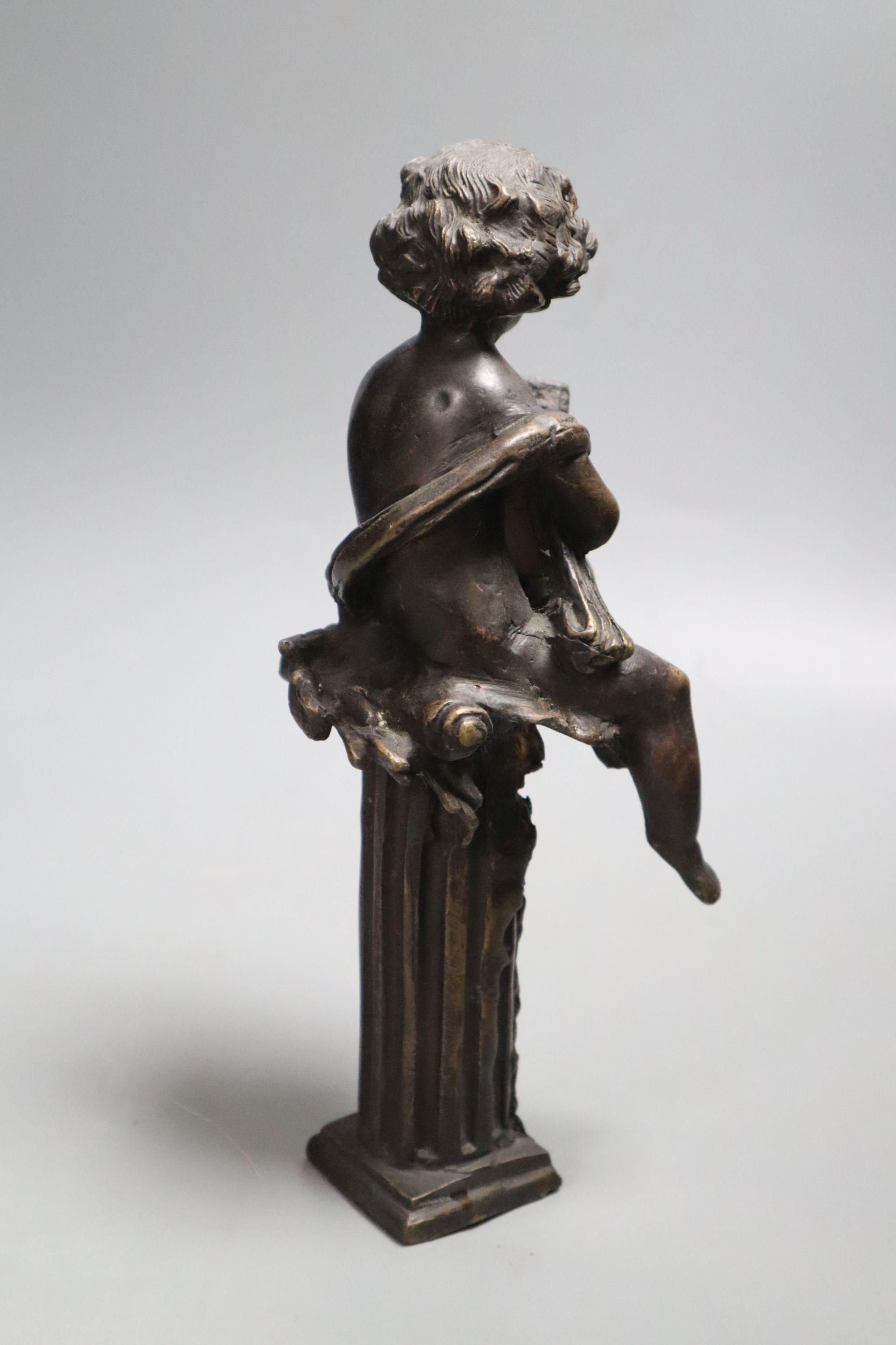 A decorative bronze cherub on pedestal, height 26cm